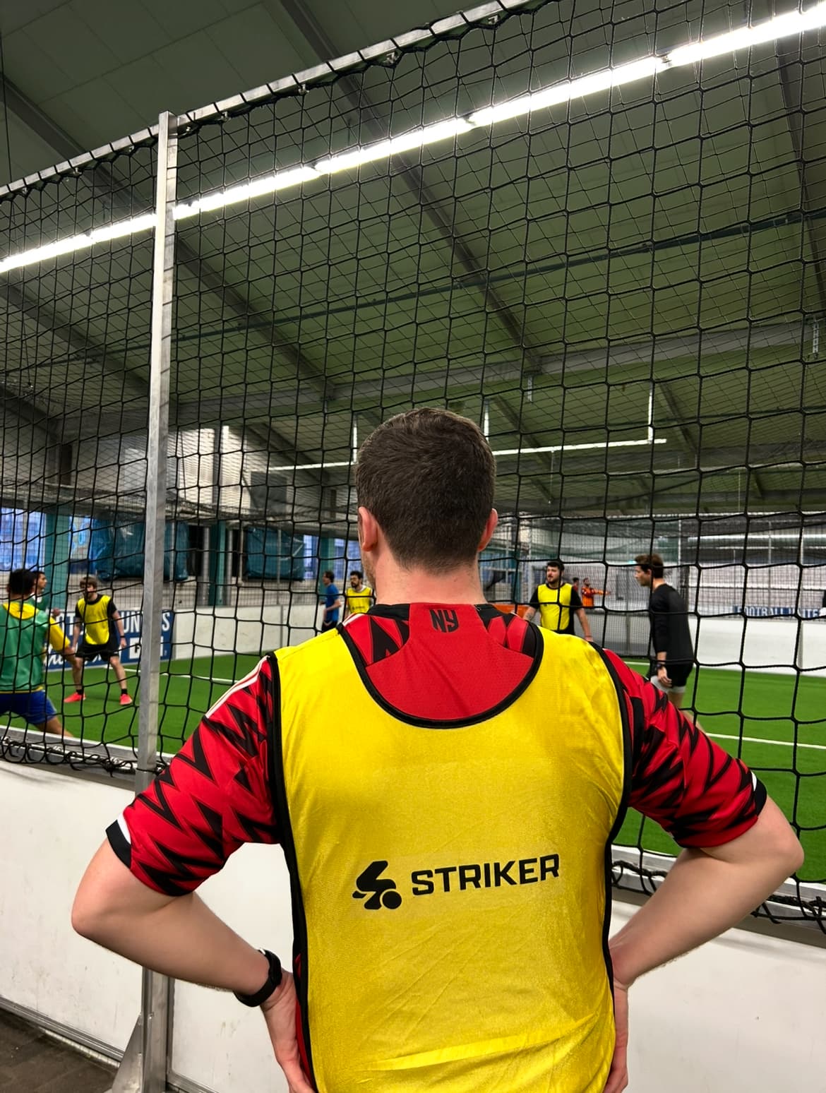 Player wearing bib during indoor football in Zurich